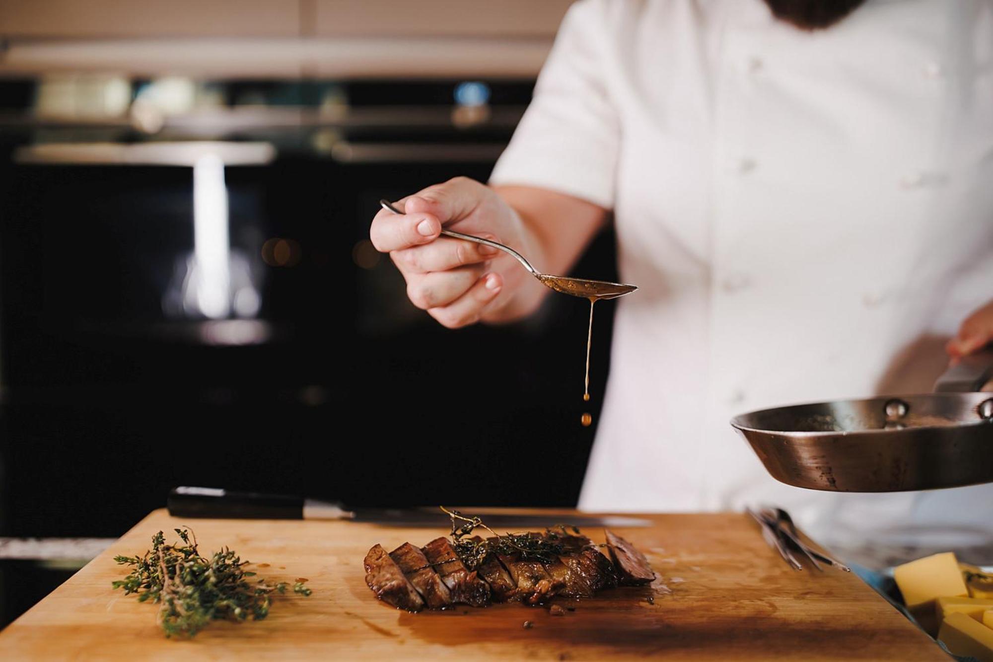 Stock Exchange Hotel, Manchester, Autograph Collection Bagian luar foto A chef seasoning a dish